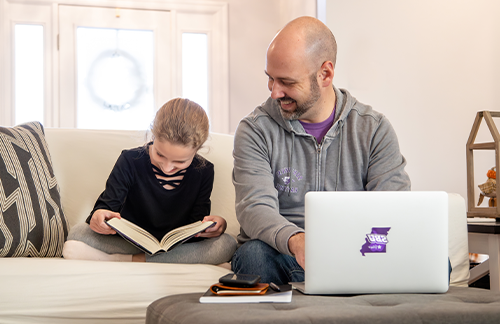 dad and daughter working on homework together